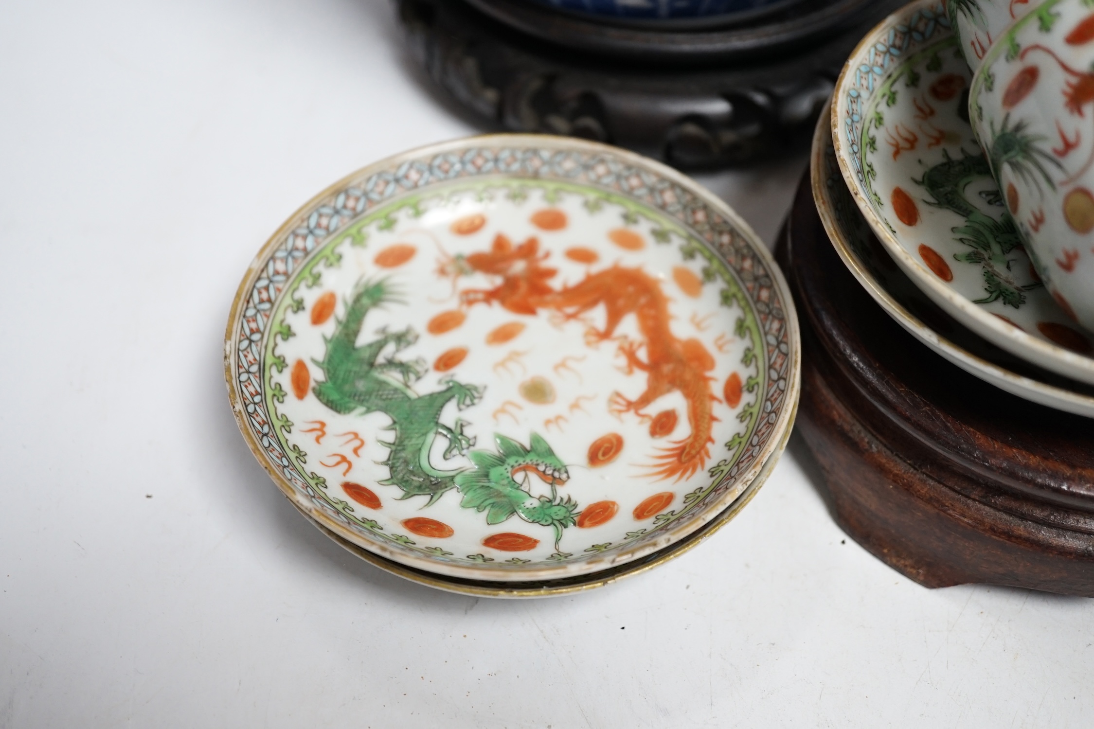 A pair of Chinese blue and white barrel jars, various cups and saucers and three hardwood stands, largest 21cm high